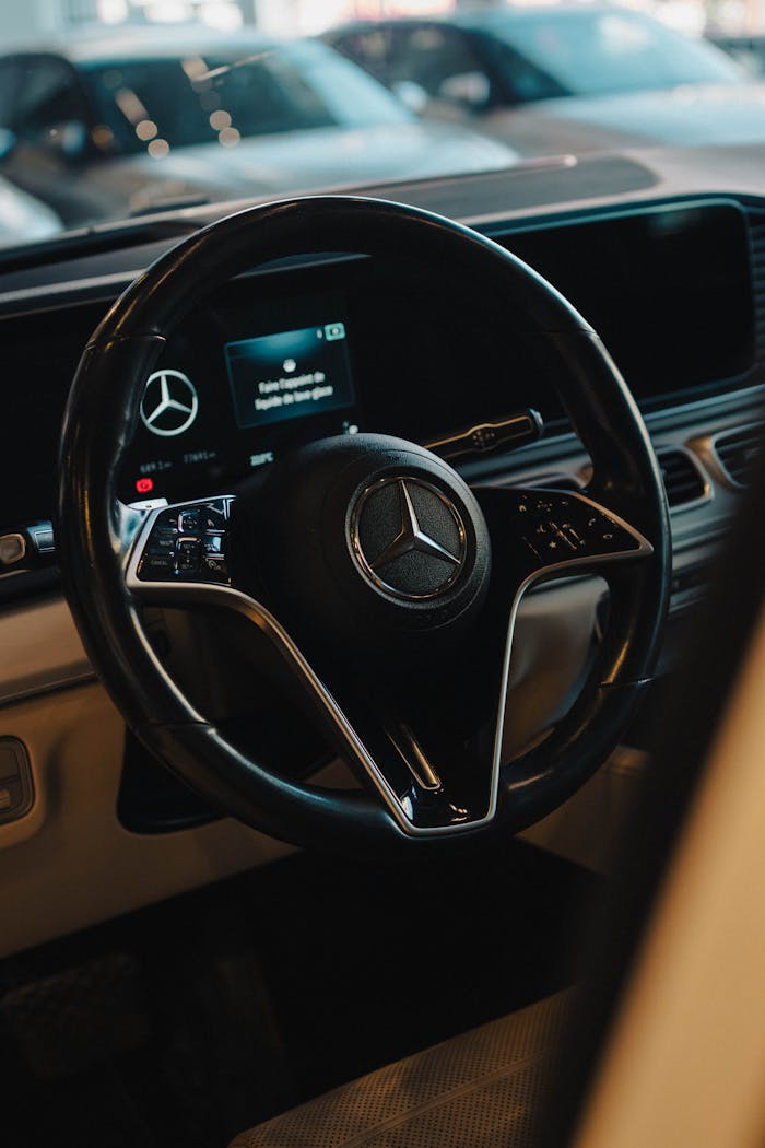 Close-up view of luxury SUV steering wheel interior with Mercedes-Benz logo in Draria, Algeria.